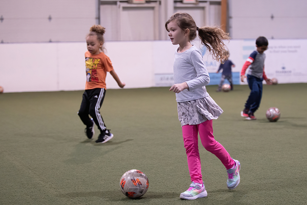 small children participating in Locker Soccer Academy dribbling exercise