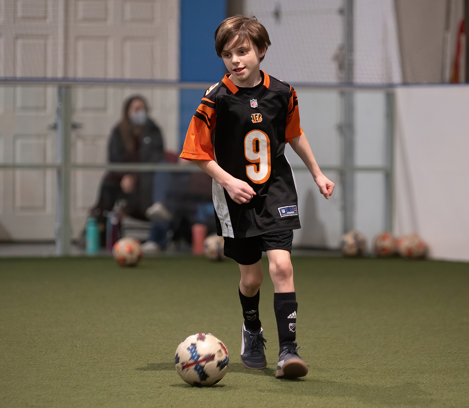 a young man in a soccer uniform participates in drills