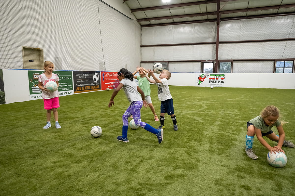 young soccer players enjoying an open gym indoors