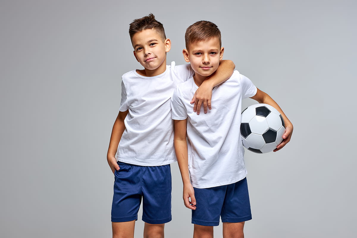 two young soccer players in fun embrace