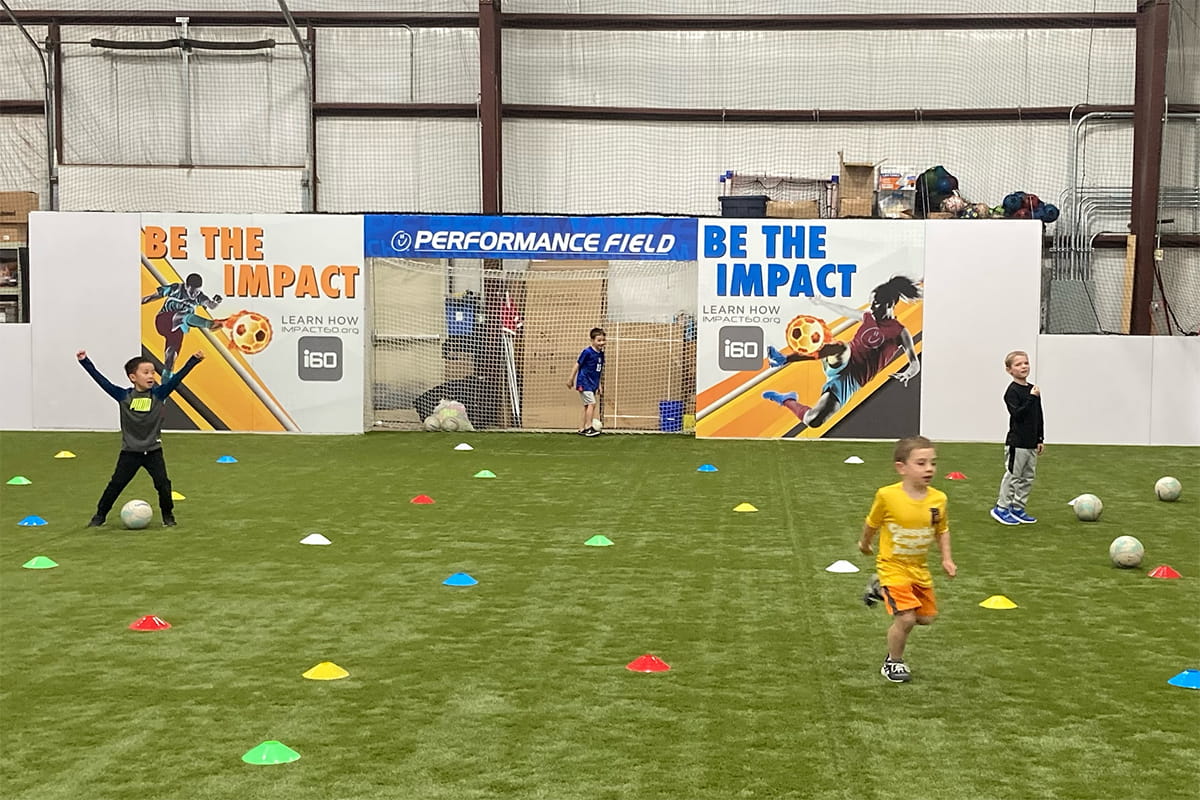 young elementary aged players participating in indoor soccer drills