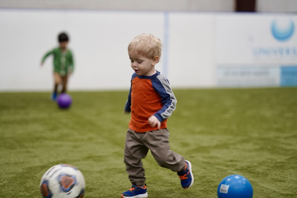 Little Kickers, little boy dribbling ball