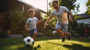 father and sun playing backyard soccer