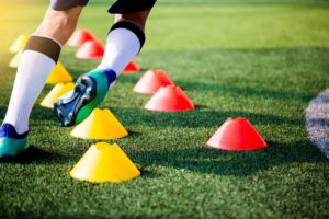 young child participating in cone minefield soccer drill