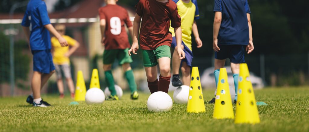 A group of youth soccer players participating in outdoor drills during an evaluation at Locker Soccer Academy.