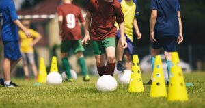 A group of youth soccer players participating in outdoor drills during an evaluation at Locker Soccer Academy.