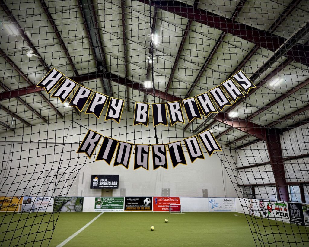 A custom "Happy Birthday" banner designed for the Locker Soccer premium party package, featuring soccer-themed elements in black and yellow.