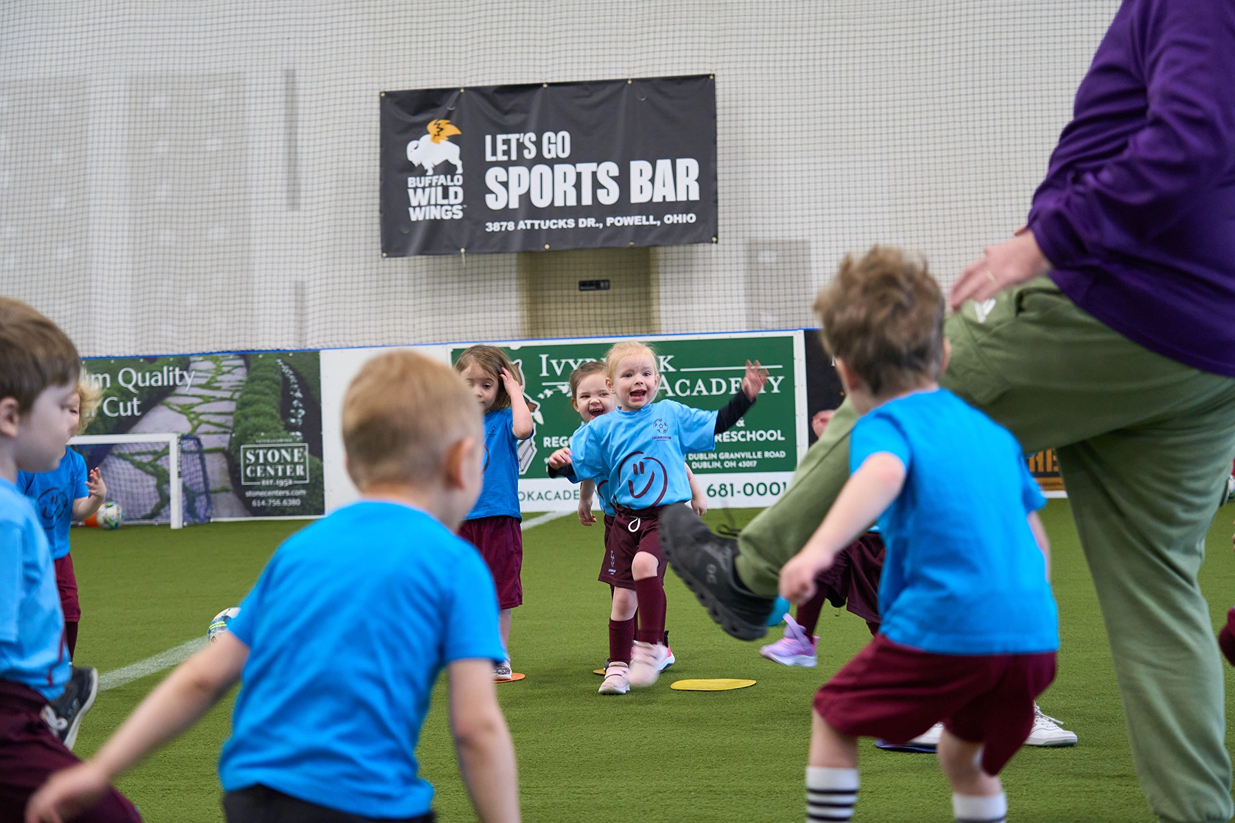 Smiling 4-5 year old girl enjoying indoor Little Kickers soccer class with fun drills during Locker Soccer Fall Session II registration