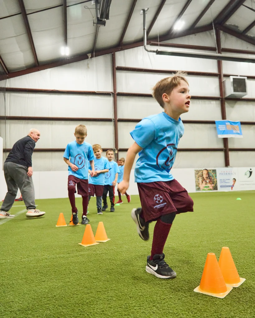 Kids hopping over cones during soccer agility and coordination drill