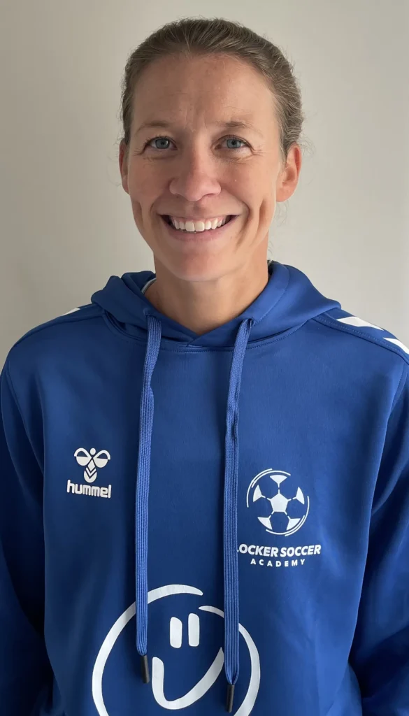 Coach Katie from Locker Soccer Academy smiling in a professional headshot photo.